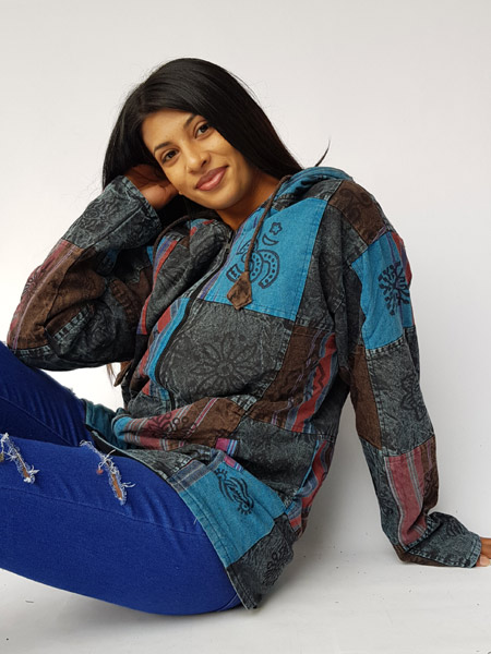 Young woman posing with a patchwork hippie jacket