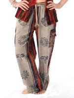 Wholesale stonewashed Buddha eyes hippie pants handmade in Nepal featuring hand-printed Buddhist symbols, vertical stripes, and functional side cargo pockets.
