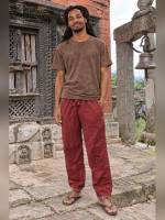 Wholesale Nepalese cotton pants in maroon featuring ethnic woven Bhutan trim on the pocket and ankle cuffs, handmade from 100% cotton in Nepal.