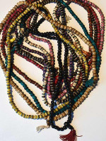 White bone mala, inlaid with turquoise and coral powder, as well as copper.