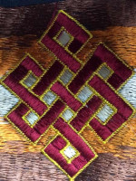 Tibetan wallet embroidered with the endless know in a variety of bright colours