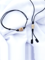 Handcrafted Tibetan skull bead bracelet and necklace set with yak bone skull beads and rosewood accents, displayed on a white fabric background.