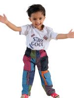 Wholesale kids' patchwork hippie pants featuring multicoloured cotton panels and side cargo pockets, handmade in Nepal with a comfortable elastic waistband.