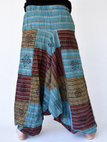 Wholesale striped patchwork harem pants handmade in Nepal featuring a drop-crotch fit, multi-colour woven cotton panels, and embroidered details.